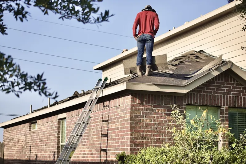 Professional roofer working on a residential roof in Thetford